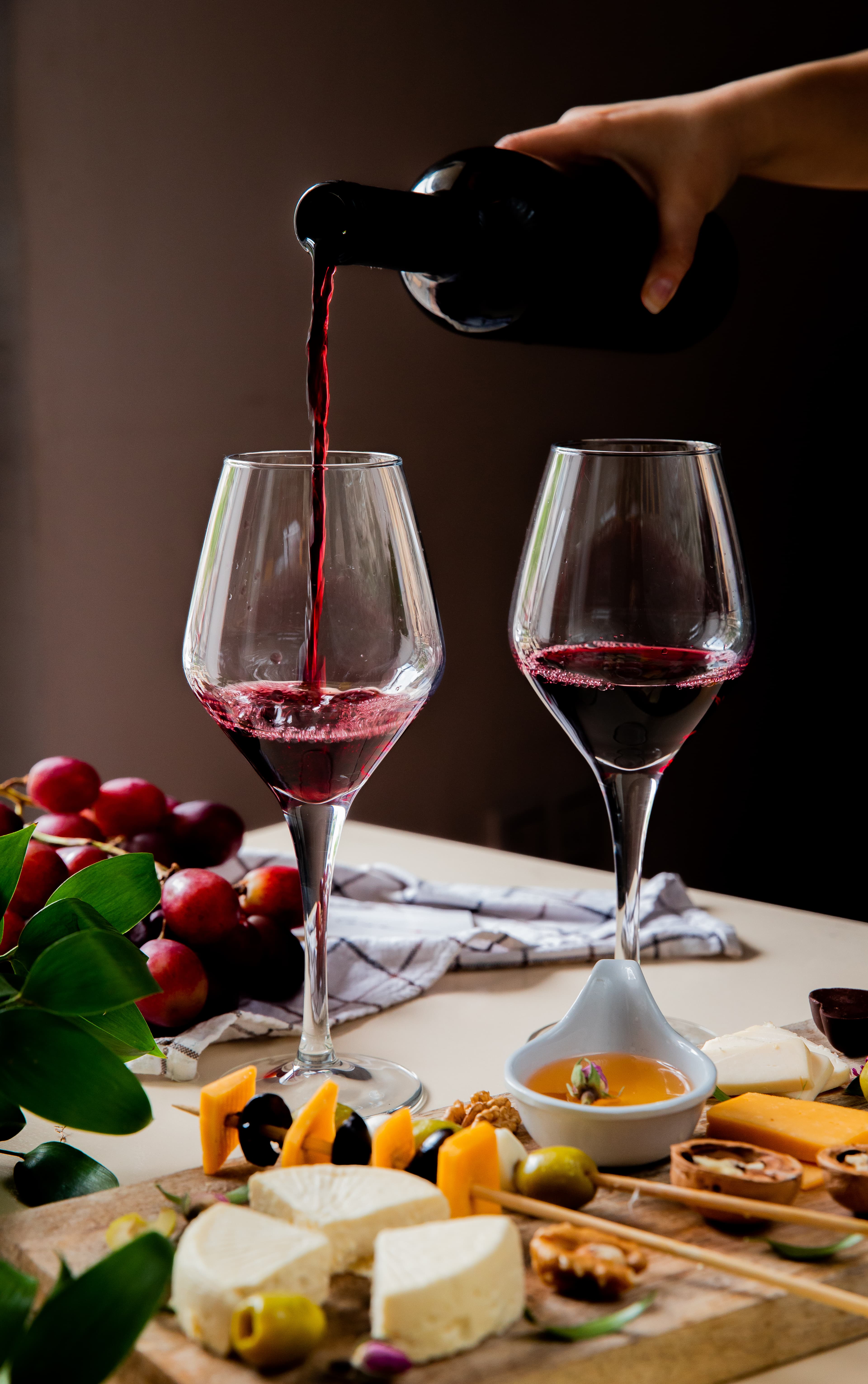 Sommelier pouring red wine into a glass